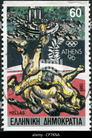 A stamp printed in Greece, dedicated to the Olympic Games in Athens-96, is shown Wrestlers and view of Delphi, circa 1989 Stock Photo