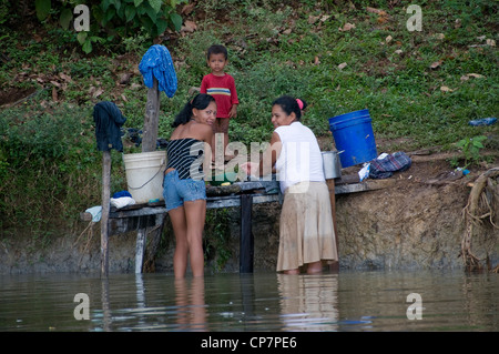 A Nicaraguan family washes clothes in the Rio San Juan near the town of Sabalos below Lake Nicaragua. Stock Photo