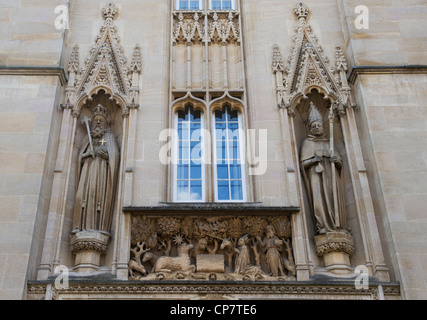 St john the baptist stone panel, Walter de Merton and Henry III stone sculpture above the entrance to Merton College, Oxford University, England Stock Photo
