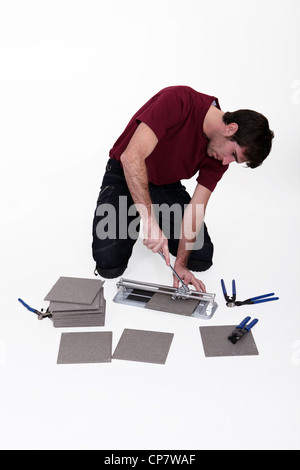 Man using tile cutter Stock Photo