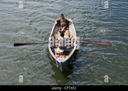 Two Mapuchi men in rowing boat Lago Budi La Arucania Chile Stock Photo