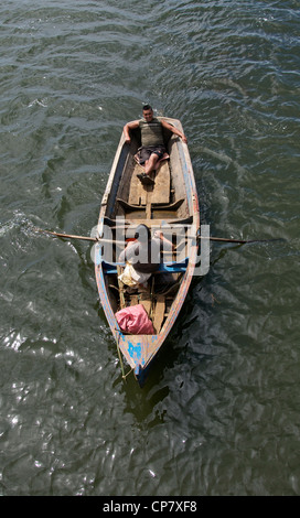 Two Mapuchi men in rowing boat Lago Budi La Arucania Chile Stock Photo