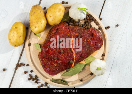 Raw steak spiced with herbs ready for baking Stock Photo