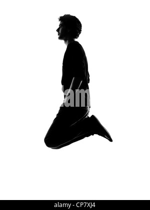 young man funny jumping silhouette in studio isolated on white background Stock Photo