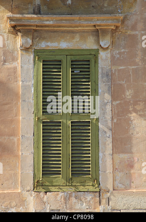 The old green window of the old stone house. Wooden wall background ...