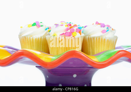 cupcakes on a colorful display plate isolated Stock Photo