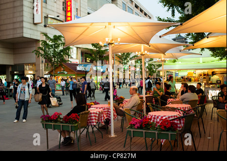 People have rest in a open bar, Wangfujing commercial street in Beijing Stock Photo