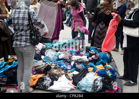 Tunis, Tunisia - Tunisian women buying clothes in the streets. Stock Photo