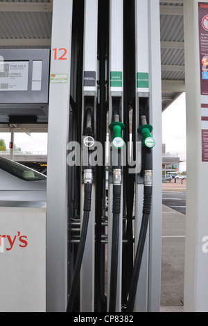 Petrol pump hoses for diesel, unleaded and super unleaded in a Sainsbury's  forecourt in Glasgow, Scotland, UK Stock Photo