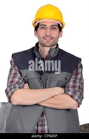 Mason stood with his arms folded Stock Photo