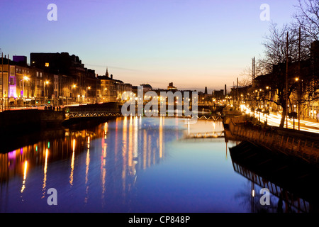 Dublin City at sunset - view over the river Liffey and historical Grattan bridge. Long exposure, tripod used. Stock Photo
