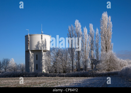 Water tower and aspen trees covered in hoar frost Cambridgeshire Stock Photo