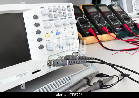 digital oscilloscope and measuring devices with cables ready for measurements in electrical laboratory Stock Photo