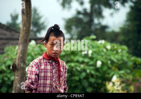 Young Basha Miao (Gun Men) boy with traditional hairstyle and red neckerchief, Southern China Stock Photo