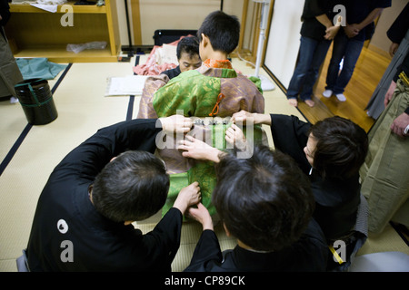 Boy being dressed for a performance in Noh Theater, Tokyo Japan. Stock Photo