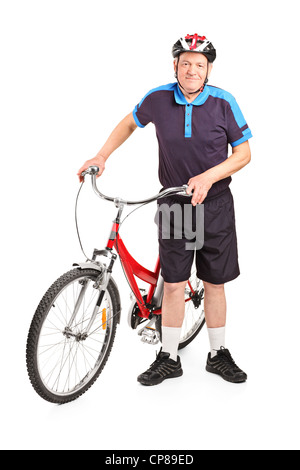 Full length portrait of a senior bicyclist posing next to a bicycle isolated on white background Stock Photo