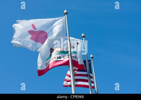 Apple Inc flag waving in the wind against blue sky. Stock Photo
