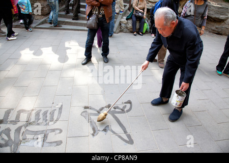 Calligraphy writing at the Jing Shan Park. Beijing, China. Stock Photo