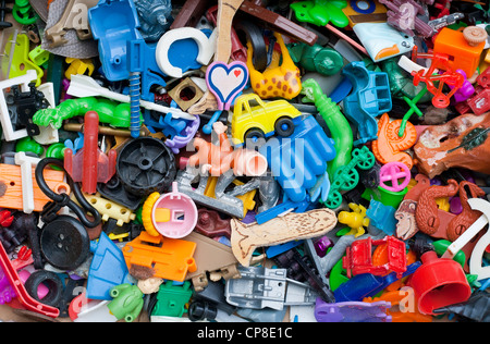 Old forgotten broken little toys background Stock Photo