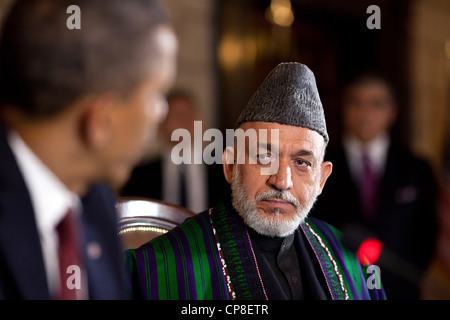 Afghan President Hamid Karzai listens to US President Barack Obama after signing the strategic partnership agreement at a signing ceremony at the Presidential Palace May 1, 2012 in Kabul, Afghanistan. Stock Photo