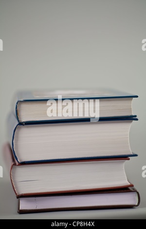 Pile of thick books on gray Stock Photo