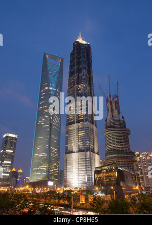 Evening view of World Financial Center JinMao Tower (center) and Shanghai Tower under construction in Lujiazui Pudong Shanghai Stock Photo