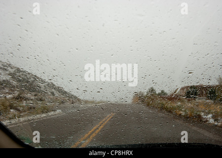 Rain drops on car windshield in a storm. Stock Photo