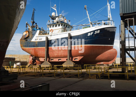 Trawler out of water in a boatyard, Macduff, Aberdeenshire, Scotland. Stock Photo