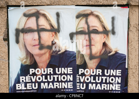 Swastika painted over posters of Marine Le Pen, France's far-right National Front political party leader - French elections 2012 Stock Photo