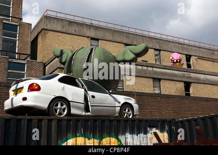 Car crushed by a winged bomb by D*Face, Dray Walk, Brick Lane, London, England, UK.