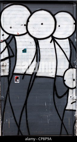 Stik figures painted on a shop front, Fieldgate Street, Whitechapel, London, UK. Stock Photo