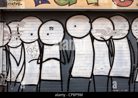 Stik figures painted on a shop front, Fieldgate Street, Whitechapel, London, UK. Stock Photo