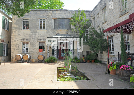 Limestone building that once held a hospital and now houses culinary shops in Fredericksburg, Texas Stock Photo