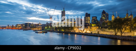 River Thames at dusk with Swiss Re Tower, Tower 42, Minster Court, Gherkin & Tower Of London in background, London, UK Stock Photo