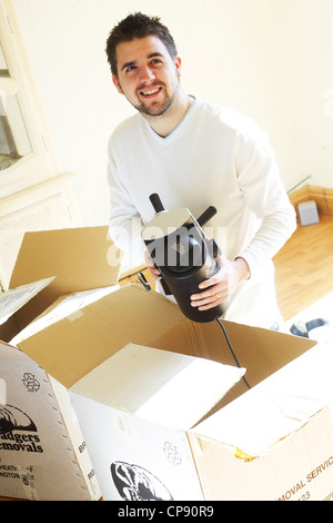 Man unpacking boxes Stock Photo