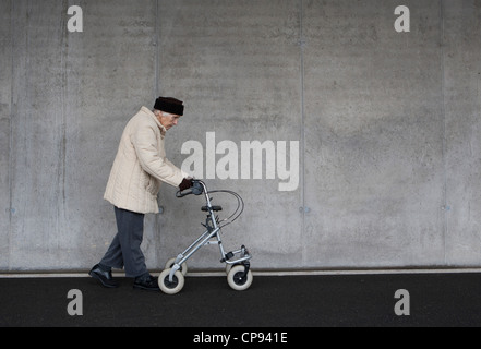 Austria,  Senior woman with wheeled walker at Subway Stock Photo