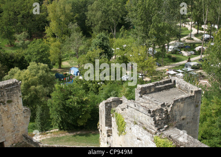 The ruins of a castle tower over a pretty campground in the Bordeaux wine growing region of France Stock Photo