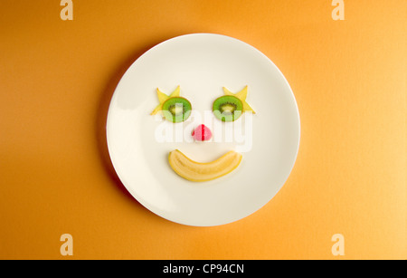 Happy face made of fruit on a plate. Stock Photo