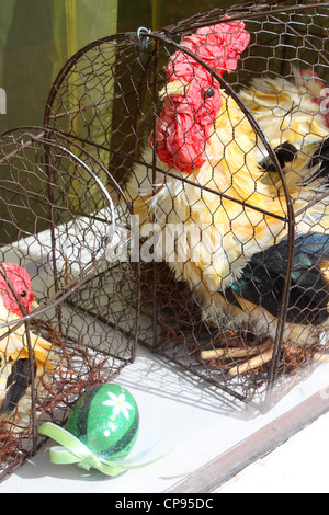 Easter toy chicken, chick, eggs in cage Stock Photo