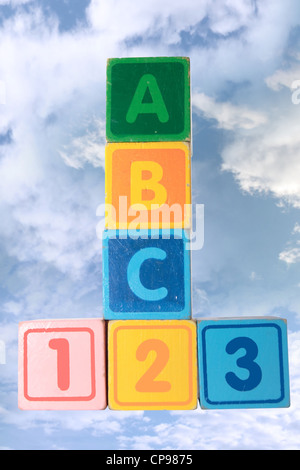 toy letter and number blocks against a cloudy background that spell abc 123 with clipping path Stock Photo