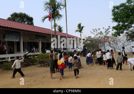 Lao school children during a presentation of books and stationary by tourists Ziemg Khuang Province Northern Laos Stock Photo