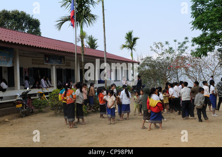 Lao school children during a presentation of books and stationary by tourists Ziemg Khuang Province Northern Laos Stock Photo