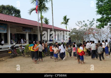 Lao school children during a presentation of books and stationary by tourists Ziemg Khuang Province Northern Laos Stock Photo