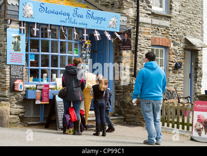 Tourists in Port Isaac, Cornwall, outside a shop selling merchandise from the Doc Martin TV series Stock Photo