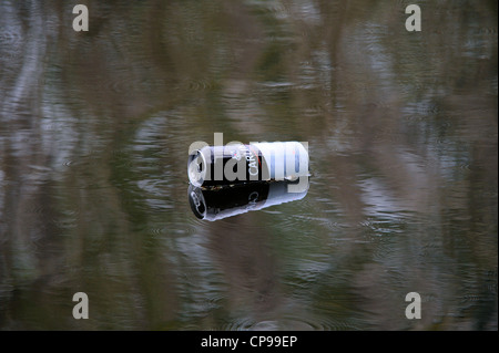 Empty and discarded Carling beer floating on a lake. Stock Photo