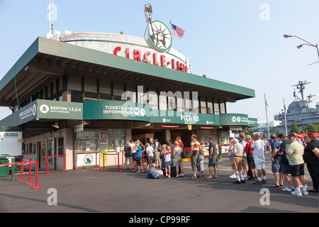 Tourists stand in line to buy tickets at the Circle Line sightseeing cruise building on Pier 83 in New York City. Stock Photo