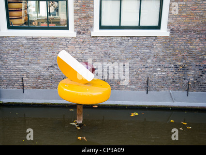 Gouda cheese camouflage on the red brick wall of grocery store in Gouda Stock Photo