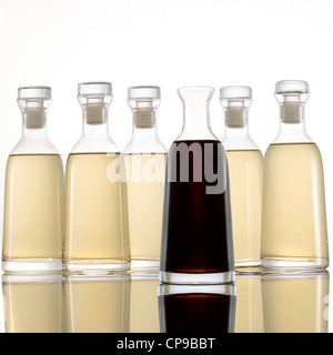 Bottled Light and Dark Vinegar on White Background Stock Photo