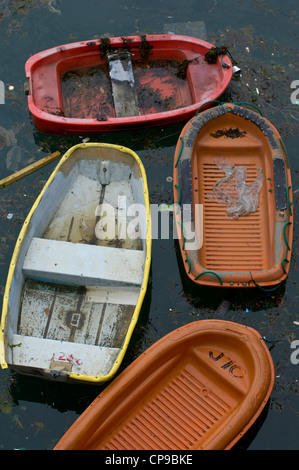 Plastic boats abandoned in harbour Stock Photo