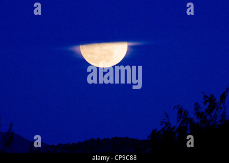 Perigree full moon, or supermoon, rises over Salida, Colorado, USA. Moon is closer to earth in orbit than normal. Stock Photo